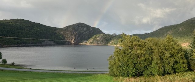 View over a lake with a rainbow in the background