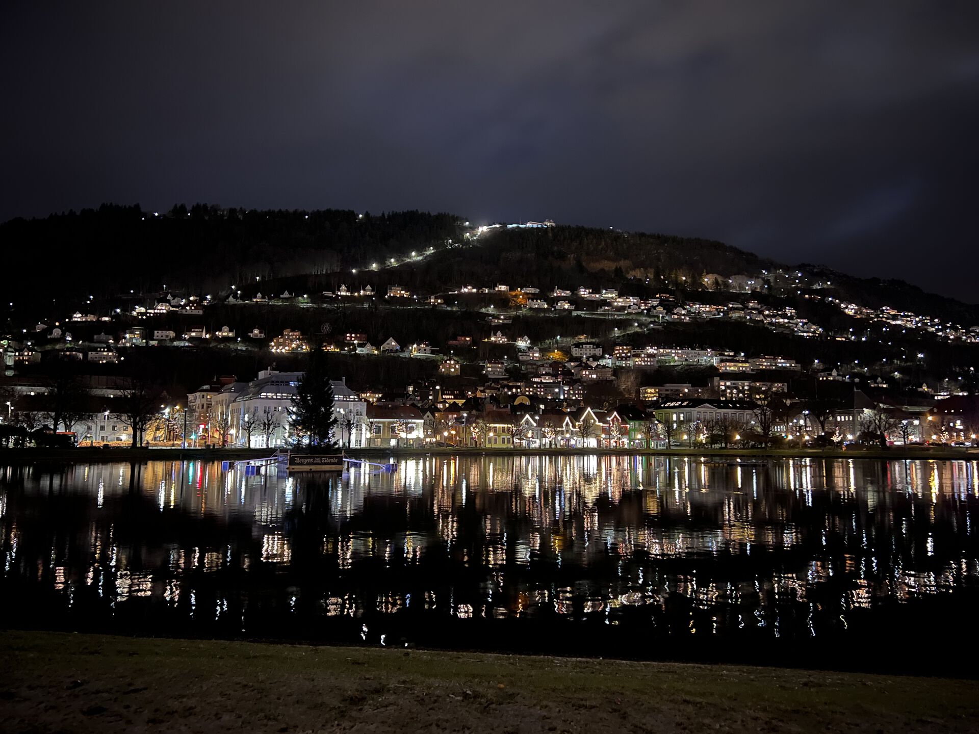 Photo of the city lake in Bergen, with reflections of the lights from the buildings around it